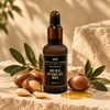 Huile d’argan bio Au Royaume d’Amira entourée de noix d’argan